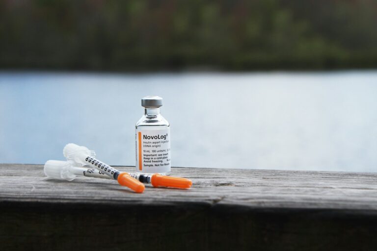 orange and white plastic bottle on brown wooden table