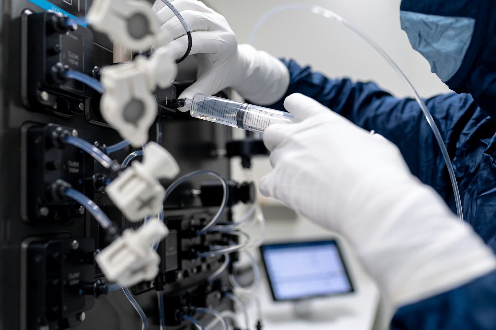 a person in a lab coat working on a computer