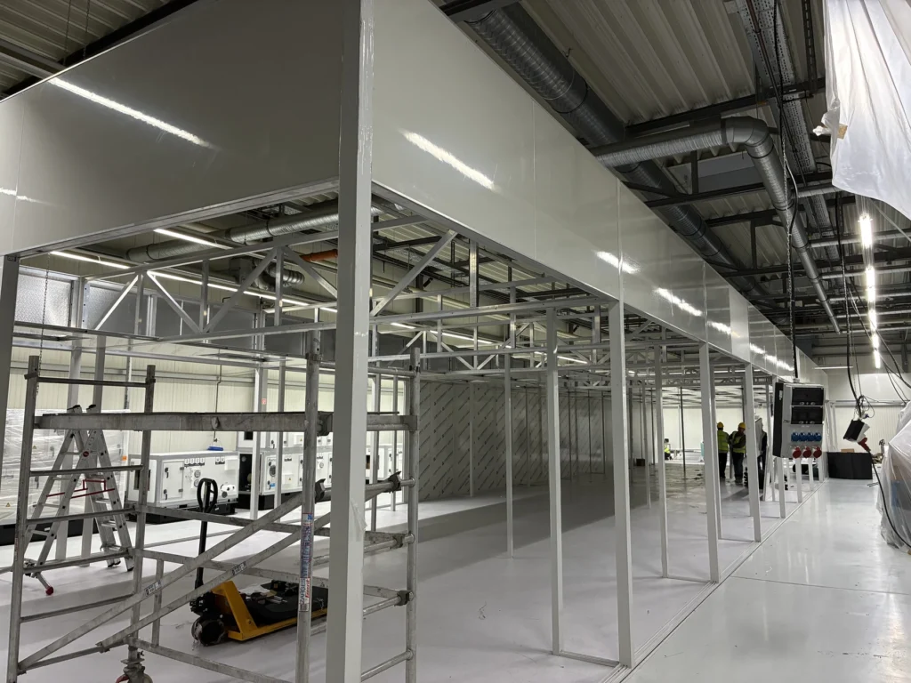 Freestanding modular cleanroom framework being assembled inside an existing German factory