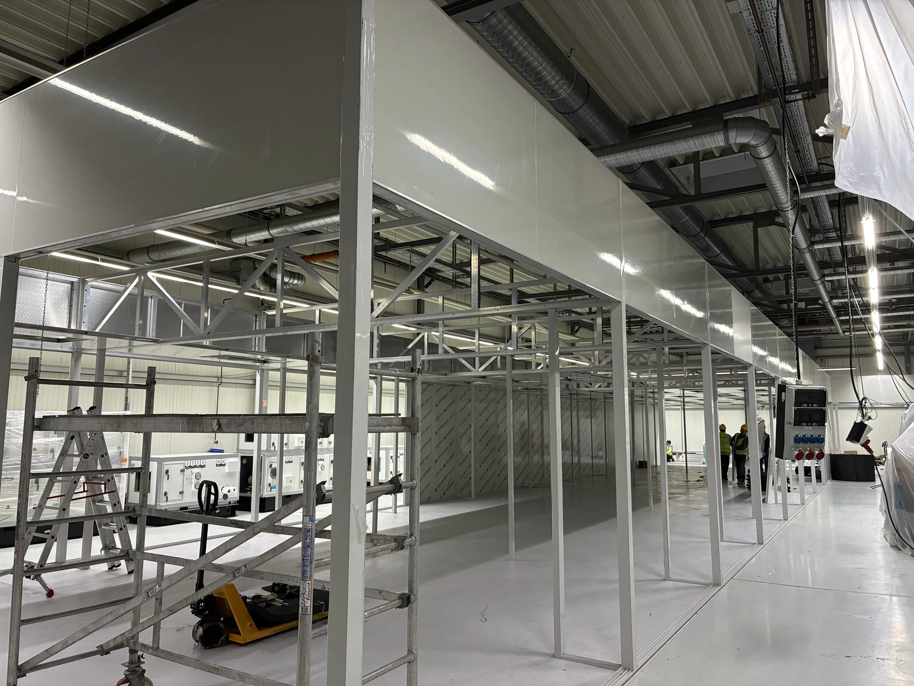 Freestanding modular cleanroom framework being assembled inside an existing German factory