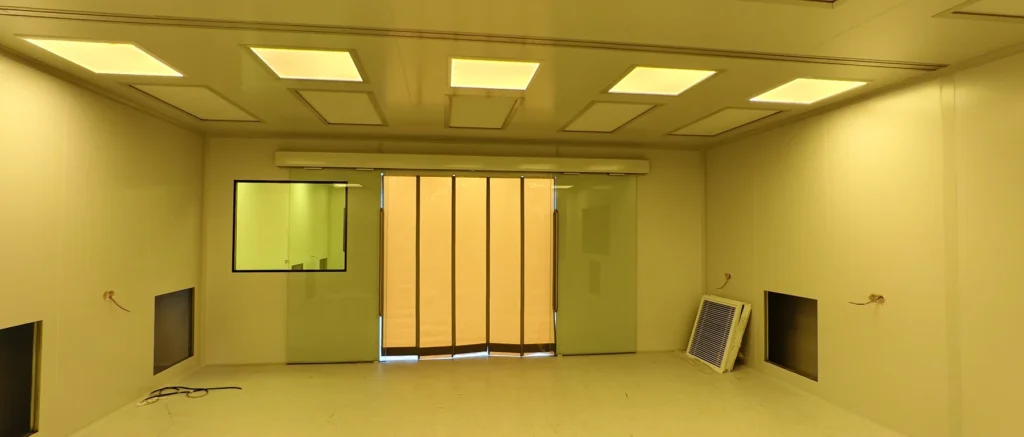 Yellow-light cleanroom workshop with yellow lighting, yellow glazing and sliding doors during installation