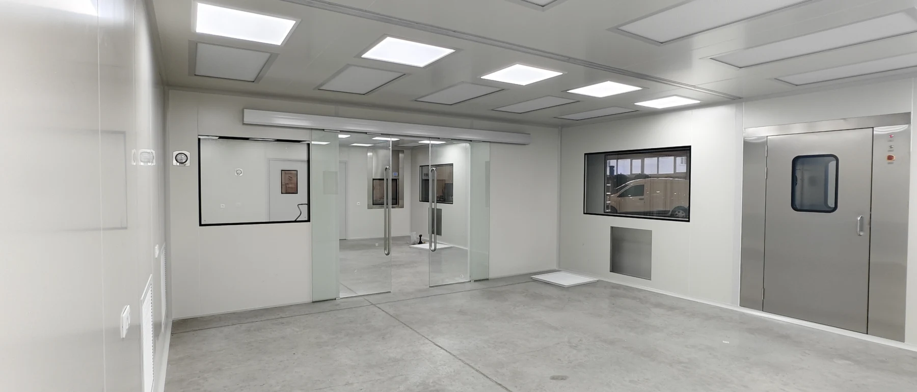 Hungary cleanroom interior with glazed separation, pass-through and stainless personnel door